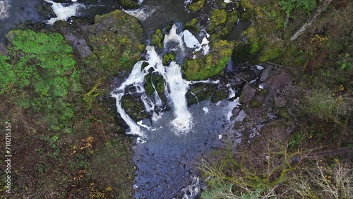 4K drone footage flying above small waterfalls in forest. Pacific Northwest America