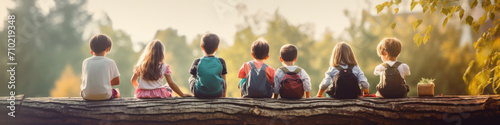Cute kids sit in a row,  engrossed in a nature-themed educational activity photo