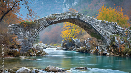 Ancient Stone Bridge Over Tranquil River in Autumn