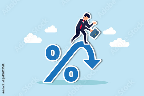 Inflation or interest rate falling down, decrease or reduction, profit fall in economic recession, stock market value loss, FED reduce interest rate, businessman on percentage sign with falling down