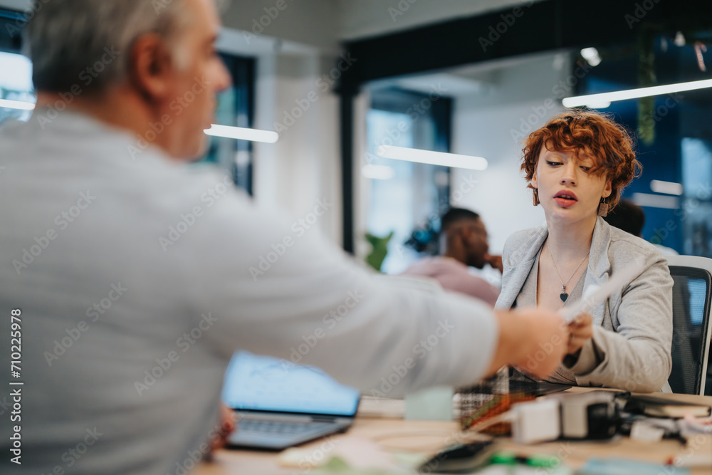 Cross generational team collaborates on business strategies, marketing, and sales in a pleasant office environment. Cross generational team collaborates on business strategies, marketing, and sales in a pleasant office environment.