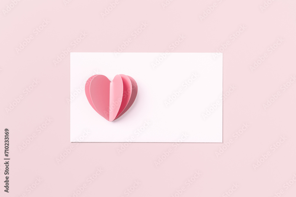 Pink cute cut heart and clean white paper for love note on pink colored ...