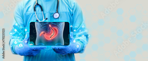 Endoscopic biopsy, esophagogastroduodenoscopy, EGD. The doctor shows the procedure of a stomach endoscopy in digital format x-ray, through a tablet. White background photo