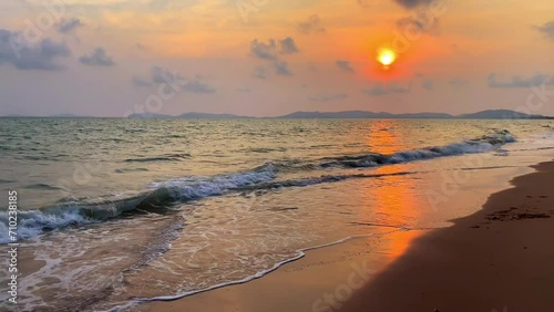 Tropical sea beach with beautiful sand and waves in summer at sunset over the sea