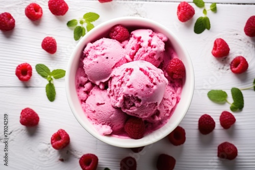 Overhead shot of raspberry ice cream in a white bowl photo