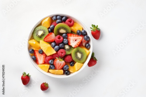 Top view of fresh fruit salad on white background