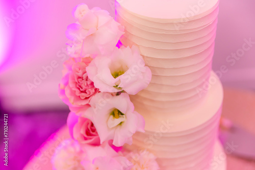 Beautiful white wedding cake decorated with flowers 