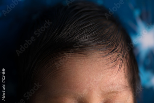 Top of newborn baby head with baby hair