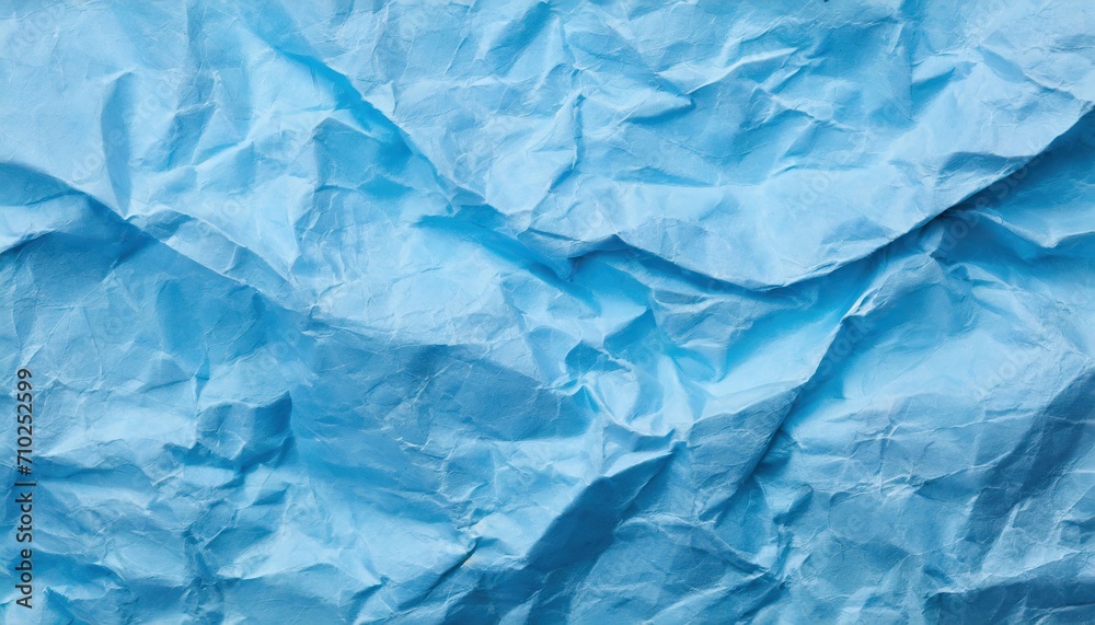 The blue crumpled paper background.
