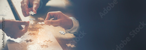 Banner Implement puzzle improve hand holding together solve synergy organize team connection plan trust strategy. Stakeholder business trust teams hands holding jigsaw puzzle synergy with copy space photo