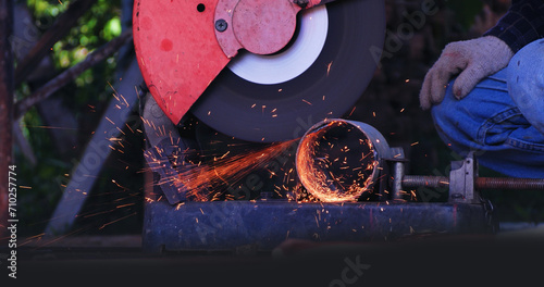 Welding machinery iron metal sparking equipment. Hot flame welding metal work cutting fire iron workshop. Locksmith using Welding machine cutting metal process grinder. Heavy Engineer metalworking photo