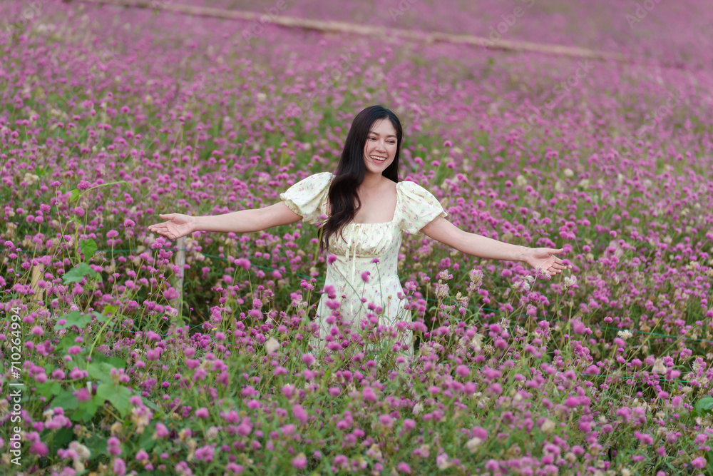 beautiful woman in dress enjoying blooming pink globe amaranth or bachelor button field beautiful woman in dress enjoying blooming pink globe amaranth or bachelor button field