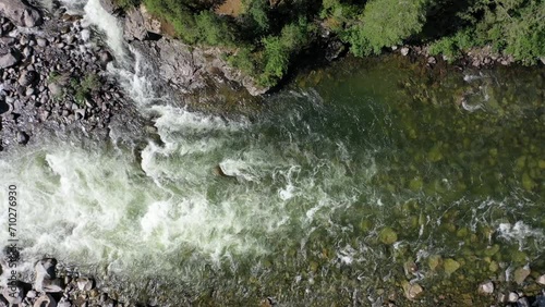 Aerial video of Altai river Chulyshman. Camera looks down. On the river banks there is siberian larch taiga forest photo