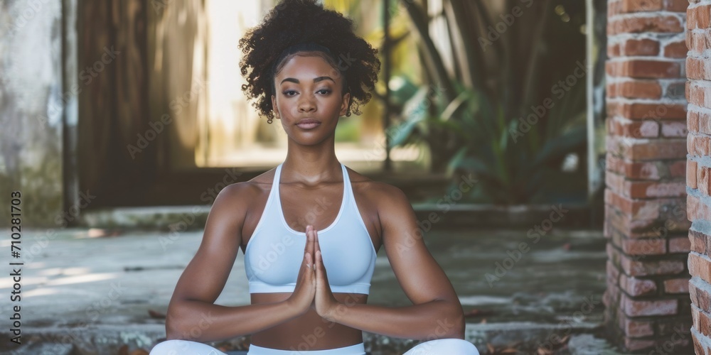 African American fitness enthusiast demonstrating a yoga pose with serenity