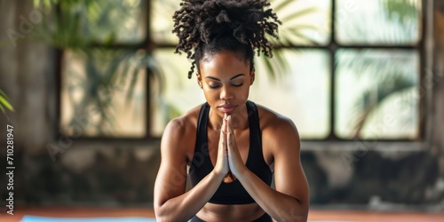 African American fitness enthusiast demonstrating a yoga pose with serenity