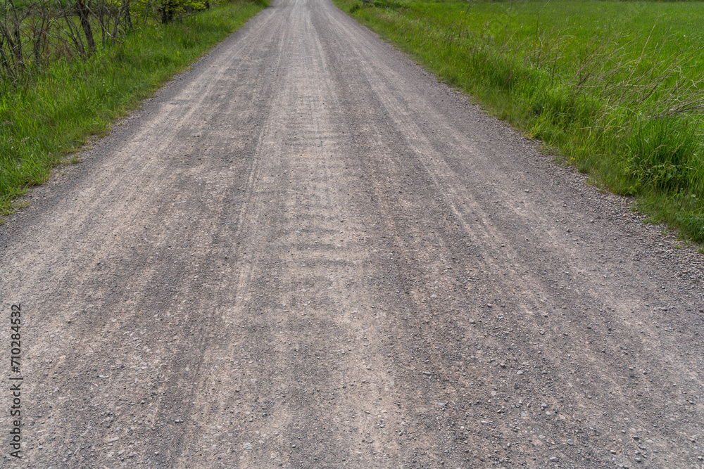 Naklejka premium Gravel road in the landscape
