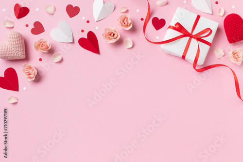 Valentine day or mother day festive composition with gift or present box, rose flowers and pink red hearts on pastel background top view. Flat lay greeting card.. photo