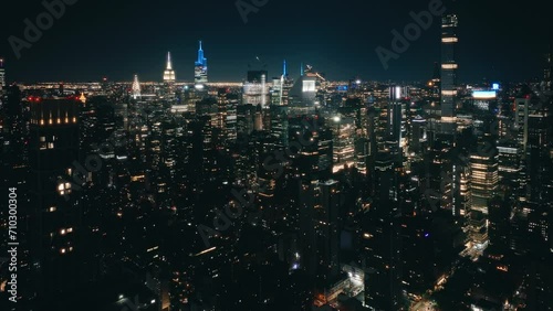 Aerial flight over NYC downtown illuminated at night. Night traffic aerial.Big Apple cityscape at night drone shot. New York city night evening buildings downtown skyline. Skyscrapers finance district