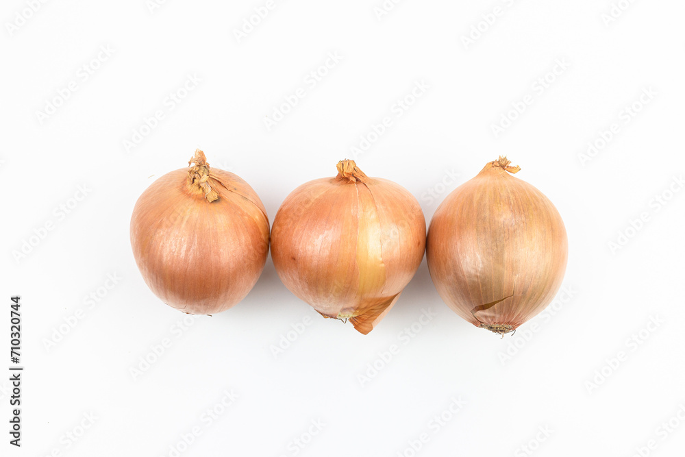 Three onions isolated on white background. Top view. Flat lay.