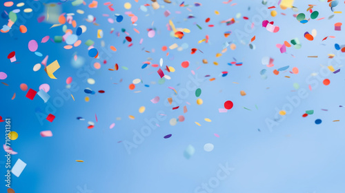 Colorful confetti flying in the air against a blue background, Generative AI