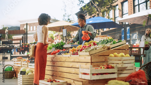 Cheerful Female Farmer Running a Small Business, Selling Sustainable Farm Fruits and Vegetables. Happy Middle Aged Woman Welcoming Shopper to Buy Natural Tomatoes and Cucumbers From a Farm