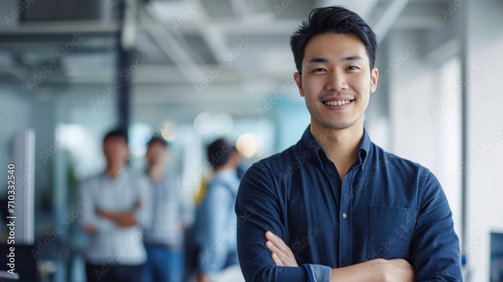 Portrait of a handsome smiling asian businessman boss standing in his modern business company office. Portrait of a handsome smiling asian businessman boss standing in his modern business company office.
