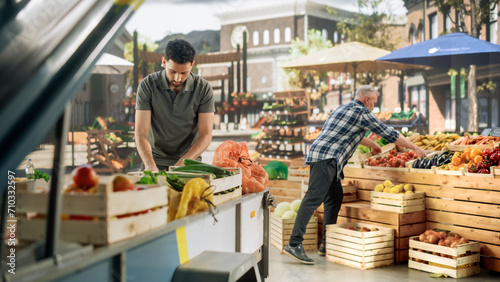 Team of Multiethnic Farmers Preparing Food Stalls for Selling Fresh Organic Farm Produce. Men Carrying Wooden Crates with Natural Fruits and Vegetables, Laying Out Products on Display in a Booth