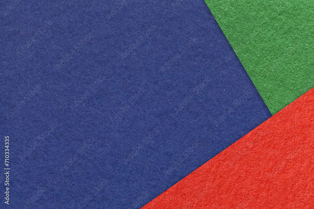 Texture of craft navy blue color paper background with green and red border. Vintage abstract denim cardboard.