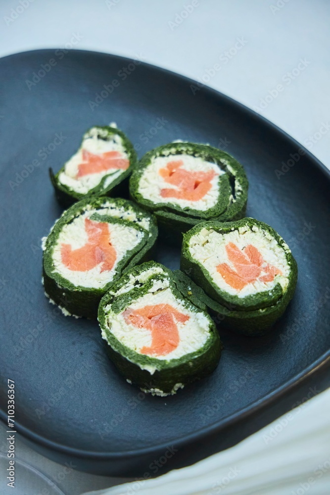Beautifully decorated serving of a dish in a restaurant or on a home festive table. Rolls with fish and cheese Beautifully decorated serving of a dish in a restaurant or on a home festive table. Rolls with fish and cheese