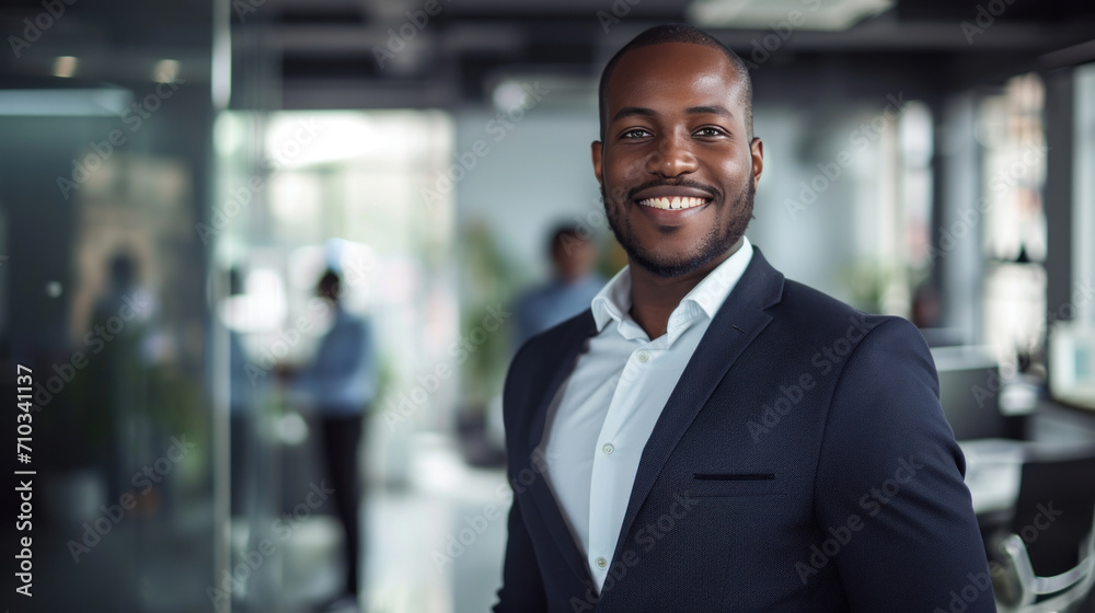 Portrait of a handsome smiling black businessman boss standing in his modern business company office. Portrait of a handsome smiling black businessman boss standing in his modern business company office.