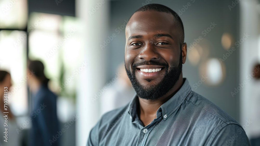 Portrait of a handsome smiling black businessman boss standing in his modern business company office. Portrait of a handsome smiling black businessman boss standing in his modern business company office.