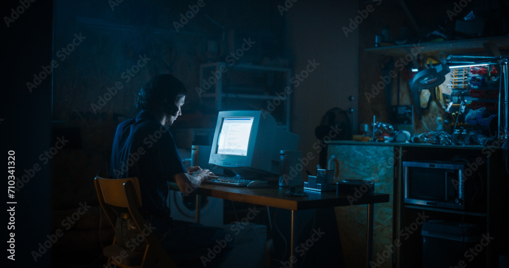 Caucasian Male Programmer Using Old Desktop Computer In Retro Garage Late At Night. White Hat Hacker Searching For Software Vulnerabilities, Coding Cyber Security System, Protecting Data In Nineties.