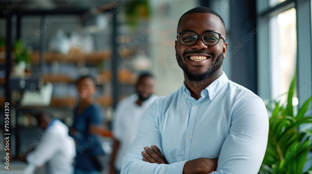 Portrait of a handsome smiling black businessman boss standing in his modern business company office. Portrait of a handsome smiling black businessman boss standing in his modern business company office.