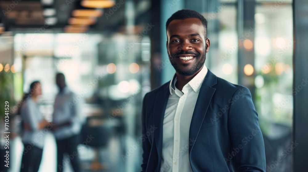 Portrait of a handsome smiling black businessman boss standing in his modern business company office. Portrait of a handsome smiling black businessman boss standing in his modern business company office.