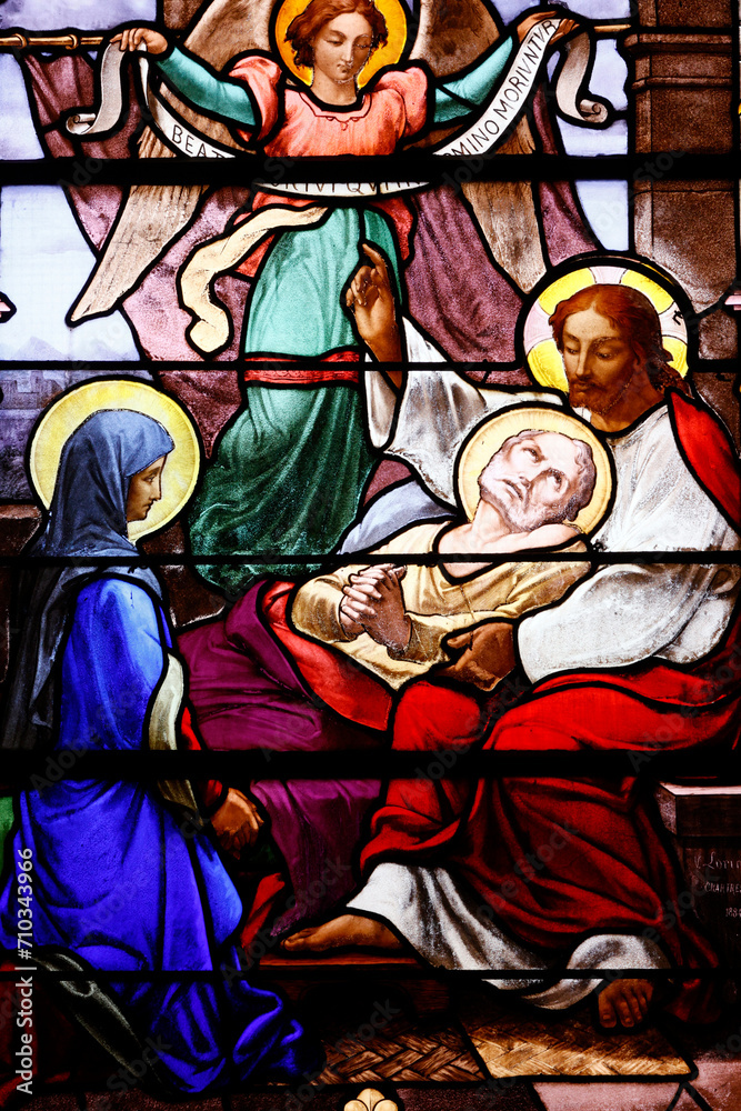 Saint Aubin church.  Stained glass.  The Death of Saint Joseph, with Mother Mary and Jesus. Houlgate. France.