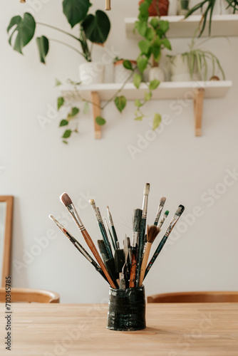 a collection of art paint brushes in the studio