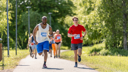 Wide Shot of Diverse Marathon Participants Competing in a Race for the Finish Line: Group of People Running Through Park Health Trail and Participating in a Marathon with Dedication