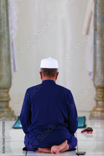 Jamiul Azhar mosque.  The friday prayer (salat). Muslim man praying in mosque. Vietnam. photo