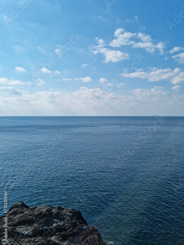 Jeju Island cliffs and blue sea.