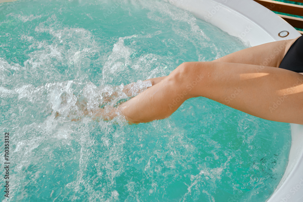 Top view of female legs in hot tub