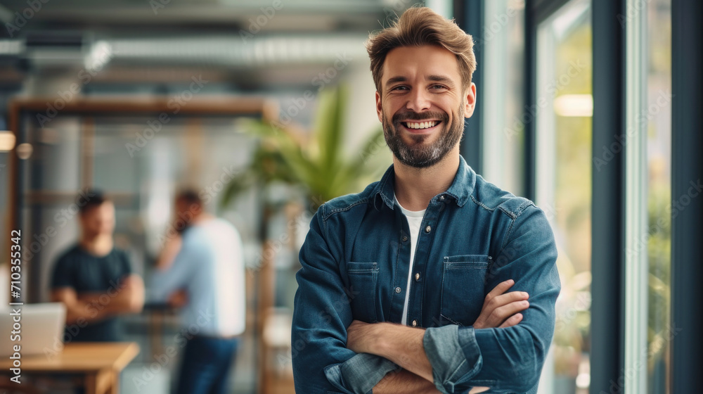 Portrait of a handsome smiling businessman boss standing in his modern business company office. Portrait of a handsome smiling businessman boss standing in his modern business company office.