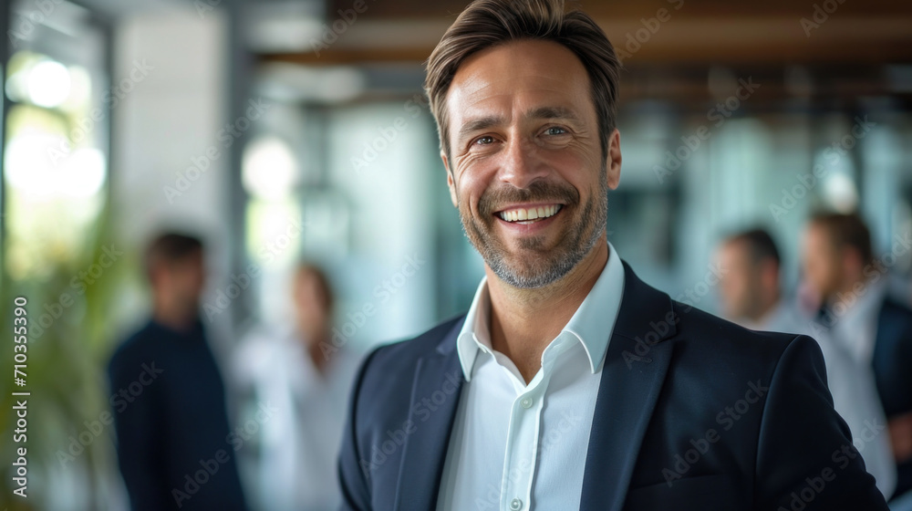 Portrait of a handsome smiling businessman boss standing in his modern business company office. Portrait of a handsome smiling businessman boss standing in his modern business company office.