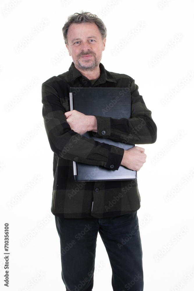 man middle aged smiling businessman holding computer and looking on white background man middle aged smiling businessman holding computer and looking on white background