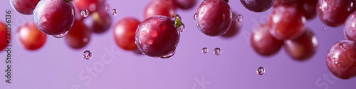 a fresh grape with a dewy surface  raindrops on the air in a purple background for a banner  wine label  copy space