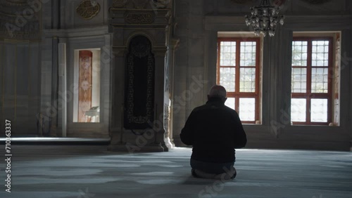Muslim Man Salah salat Pray inside Nuruosmaniye Camii Mosque Architecturally significant Ottoman mosque Istanbul, Turkey photo
