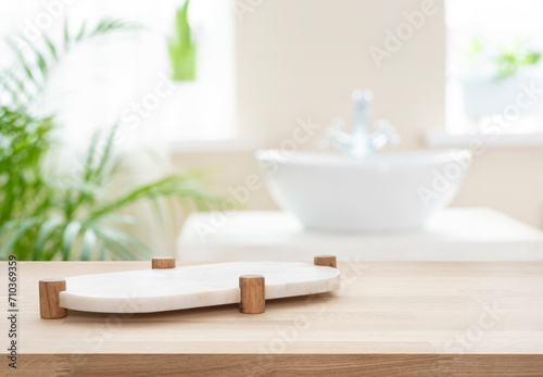 Marble white podium on table for bathing product display on blur bathroom sink background