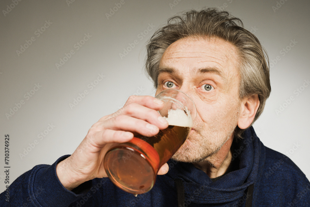 Older man eating sweet pastry and cakes as a meal in studio Older man eating sweet pastry and cakes as a meal in studio