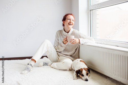 Young Woman Drinking hot coffee at white room