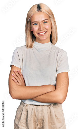 Beautiful young blonde woman wearing casual white t shirt happy face smiling with crossed arms looking at the camera. positive person. © Krakenimages.com