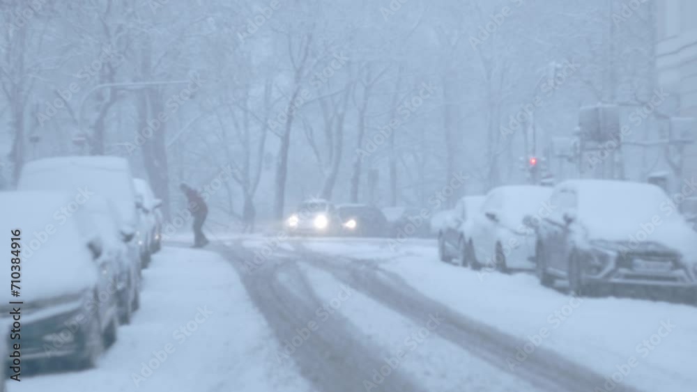 Snow storm in the middle of a metropolitan city with cars and trees. Munich, Bavaria, Germany Snow storm in the middle of a metropolitan city with cars and trees. Munich, Bavaria, Germany